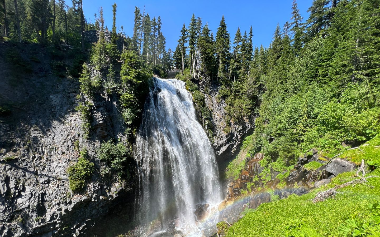 picture of a waterfall with a rainbow in the mist