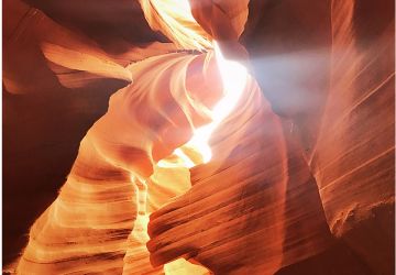 sunlight streaming through slot canyon ceiling