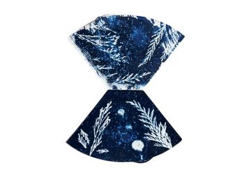 two coffee filters with dark blue botanical artwork printed on the filters